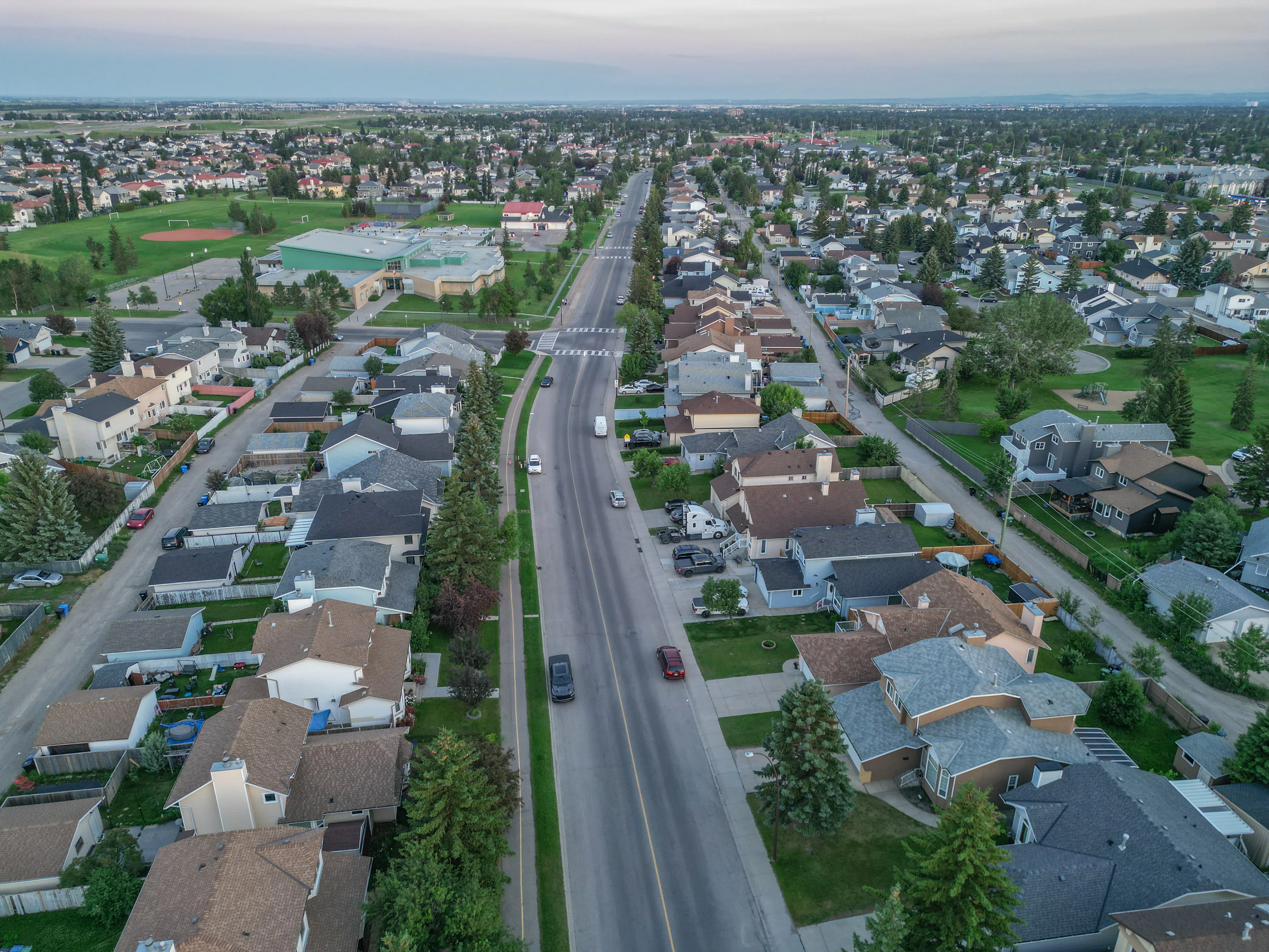 Aerial of a residential street leading to a school and park