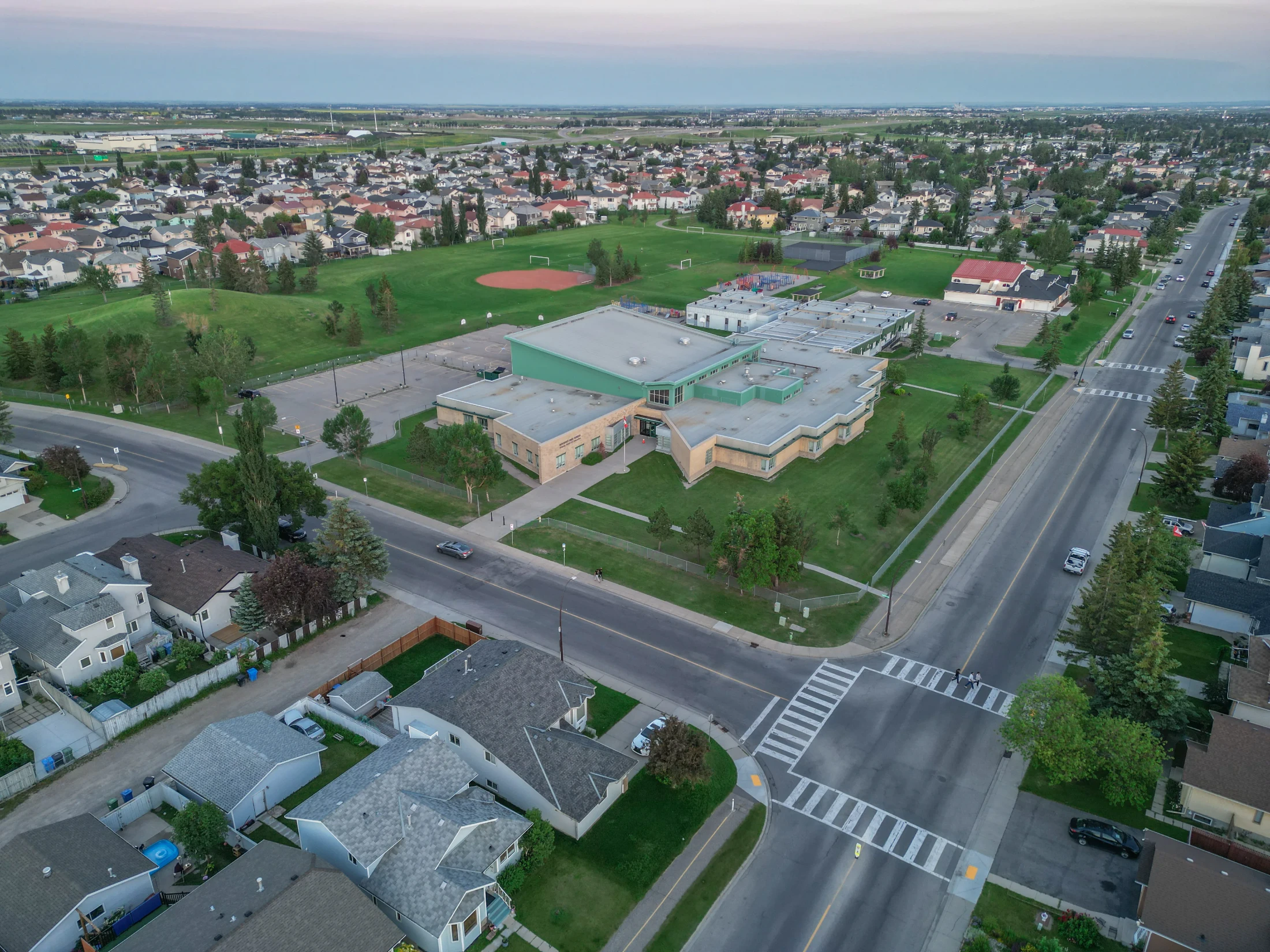 Aerial of a school with sports fields beside a residential area