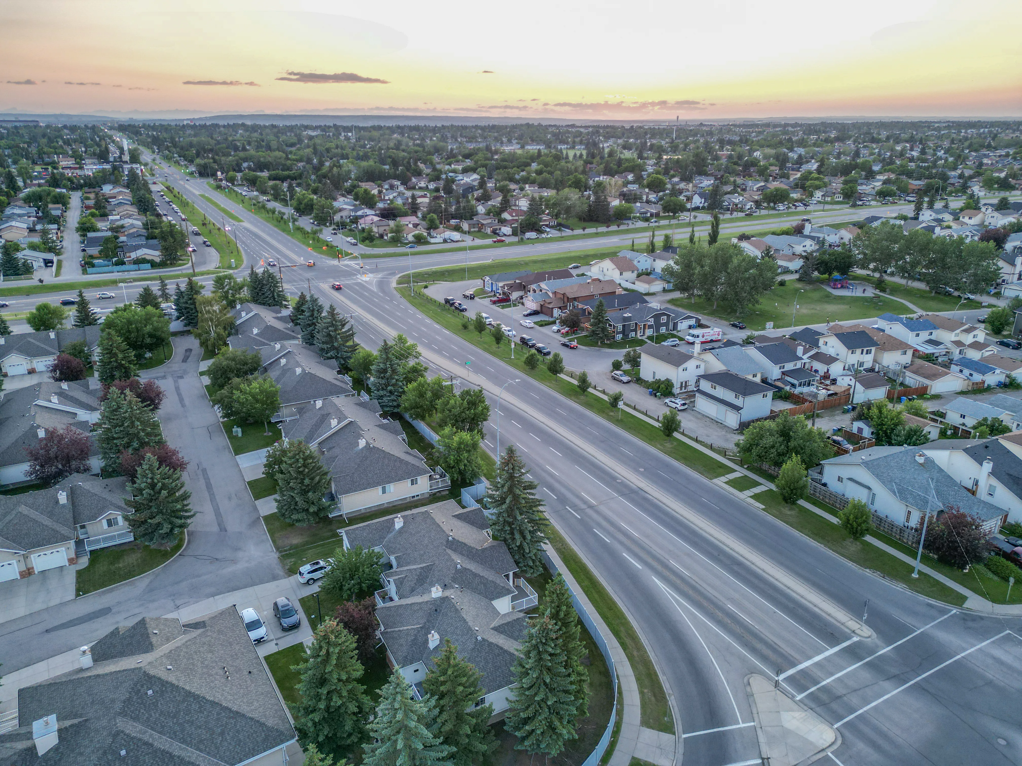 Aerial of curving residential streets with homes and trees