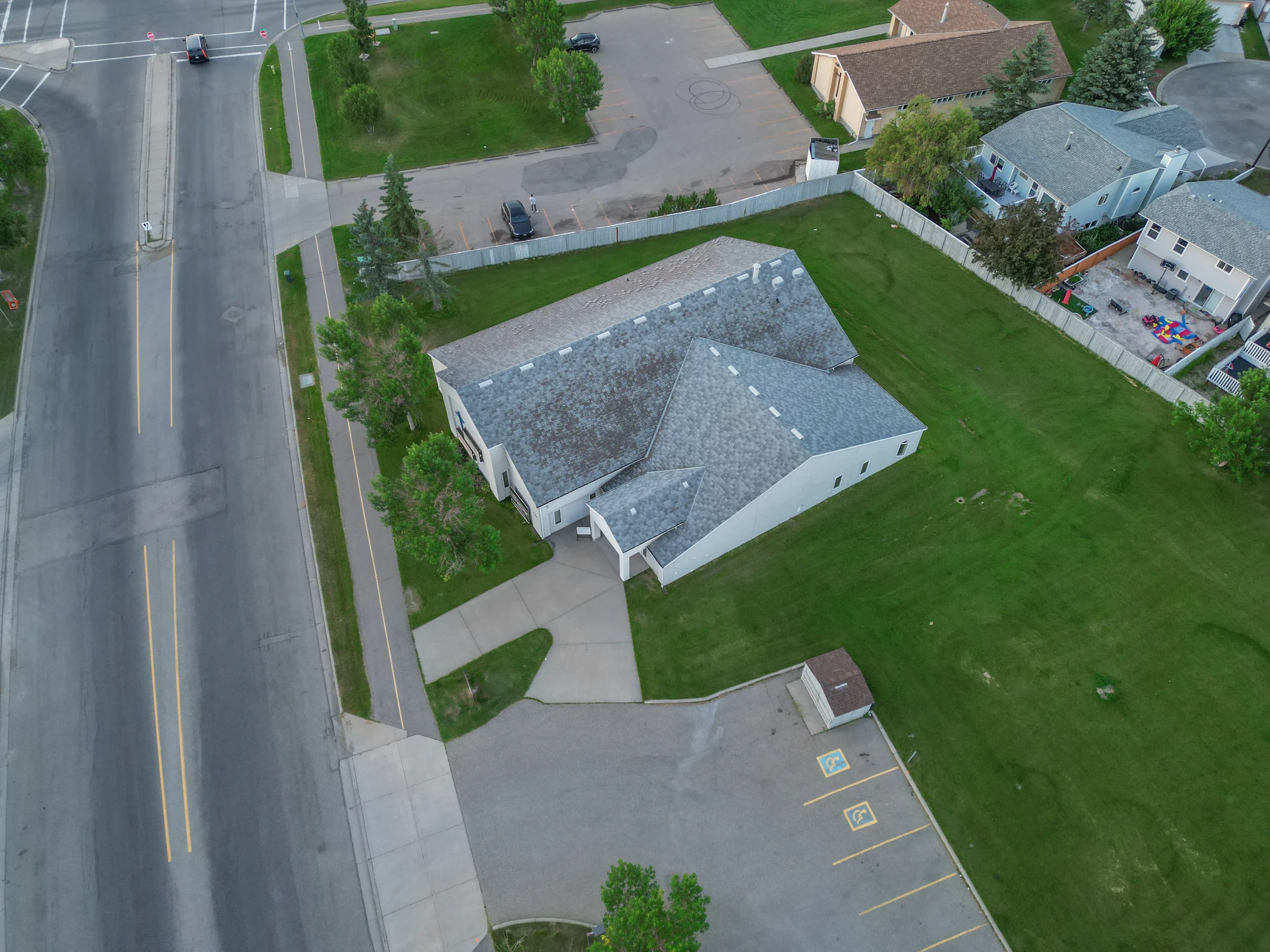 Aerial of rooftops and yards on a quiet residential street