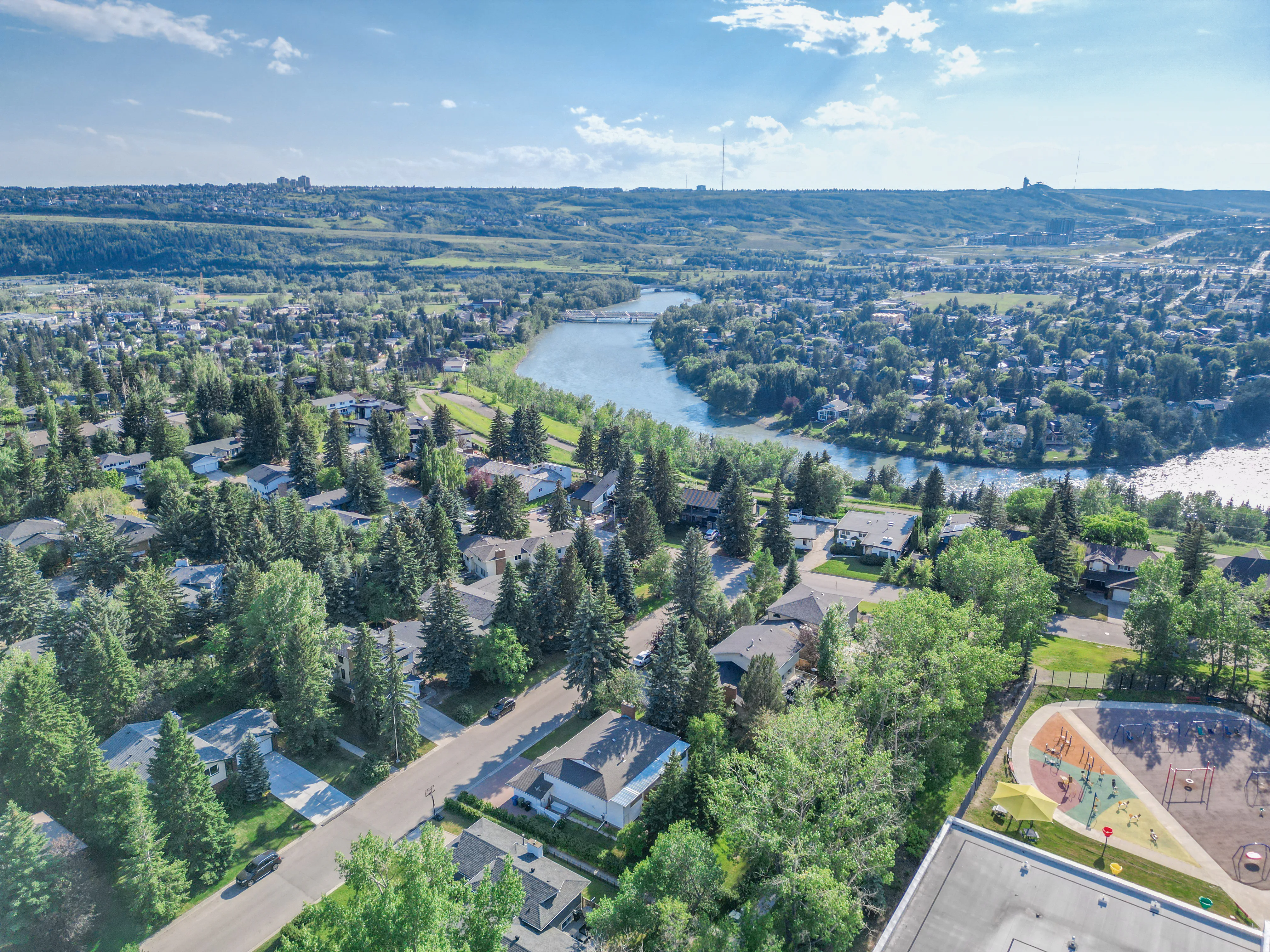 Aerial view of the Bow River valley and established homes in Calgary