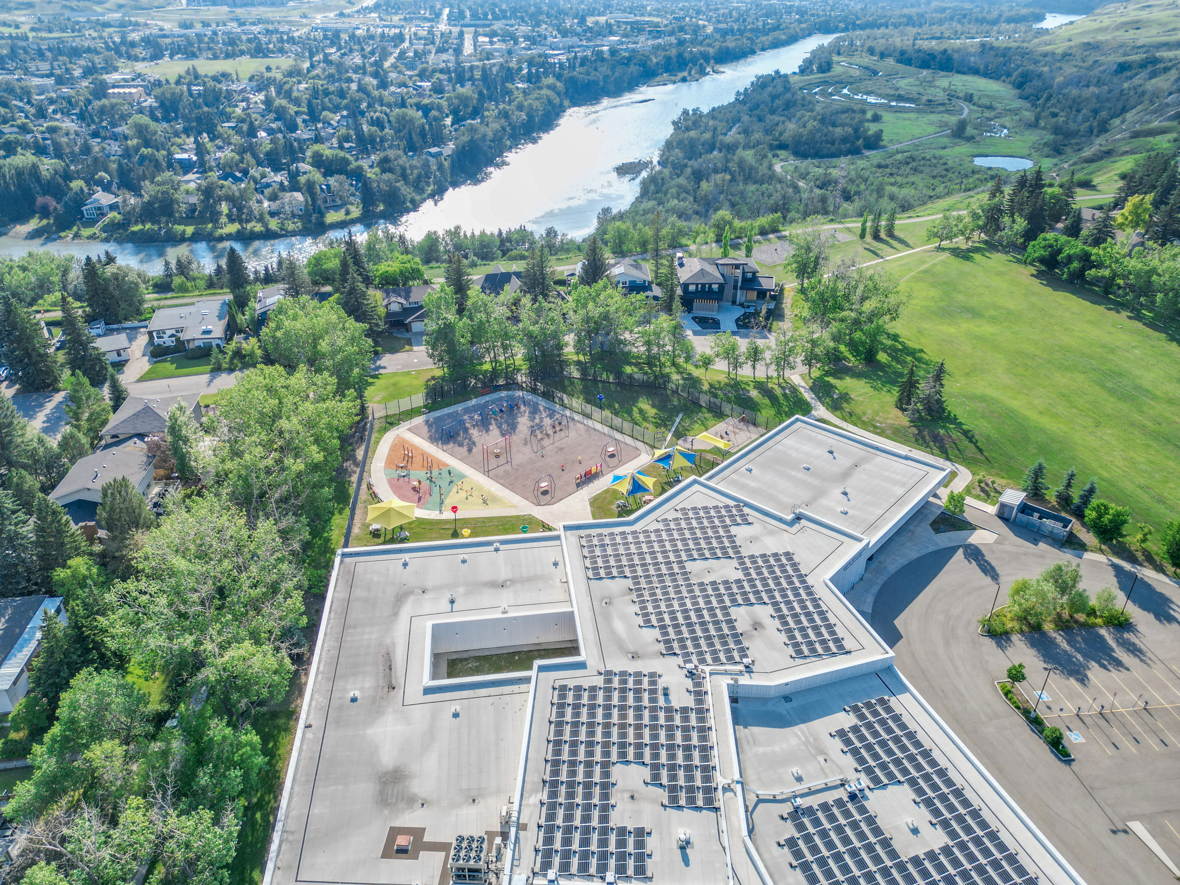 Aerial view of a school and green space near the Bow River in Montgomery, Calgary