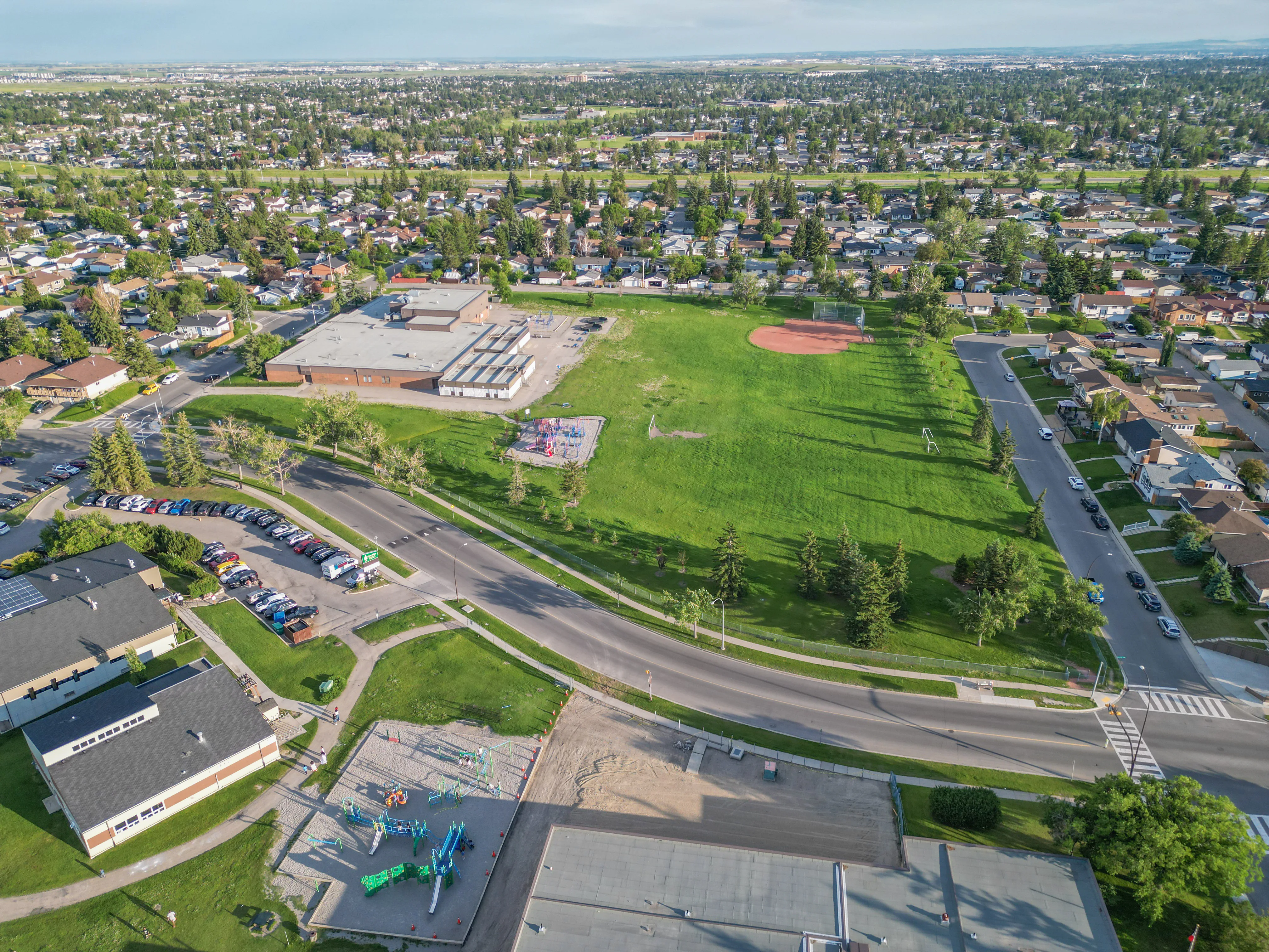 Aerial of a school, playing field and surrounding homes