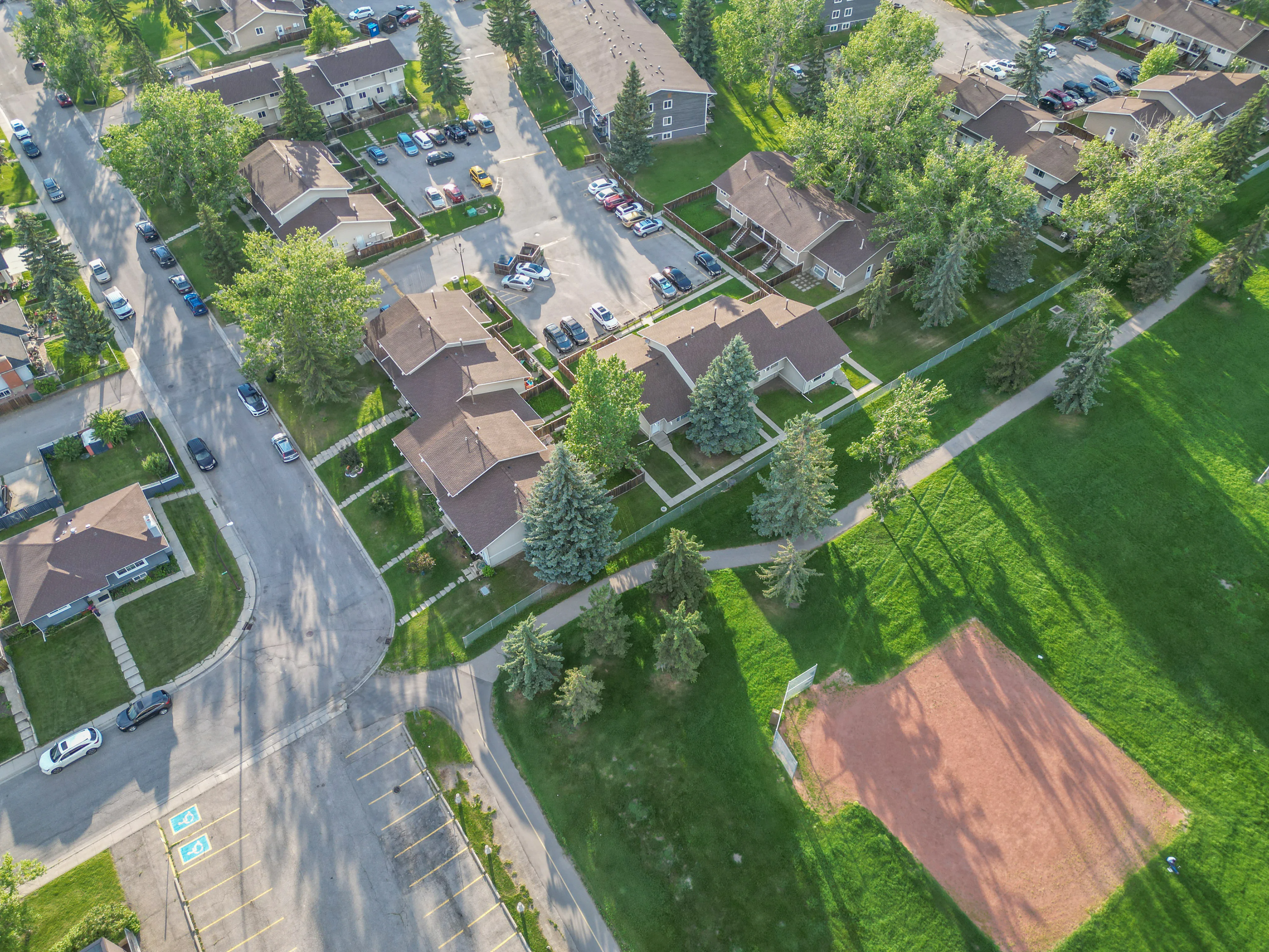 Aerial of homes, a pathway and a green space
