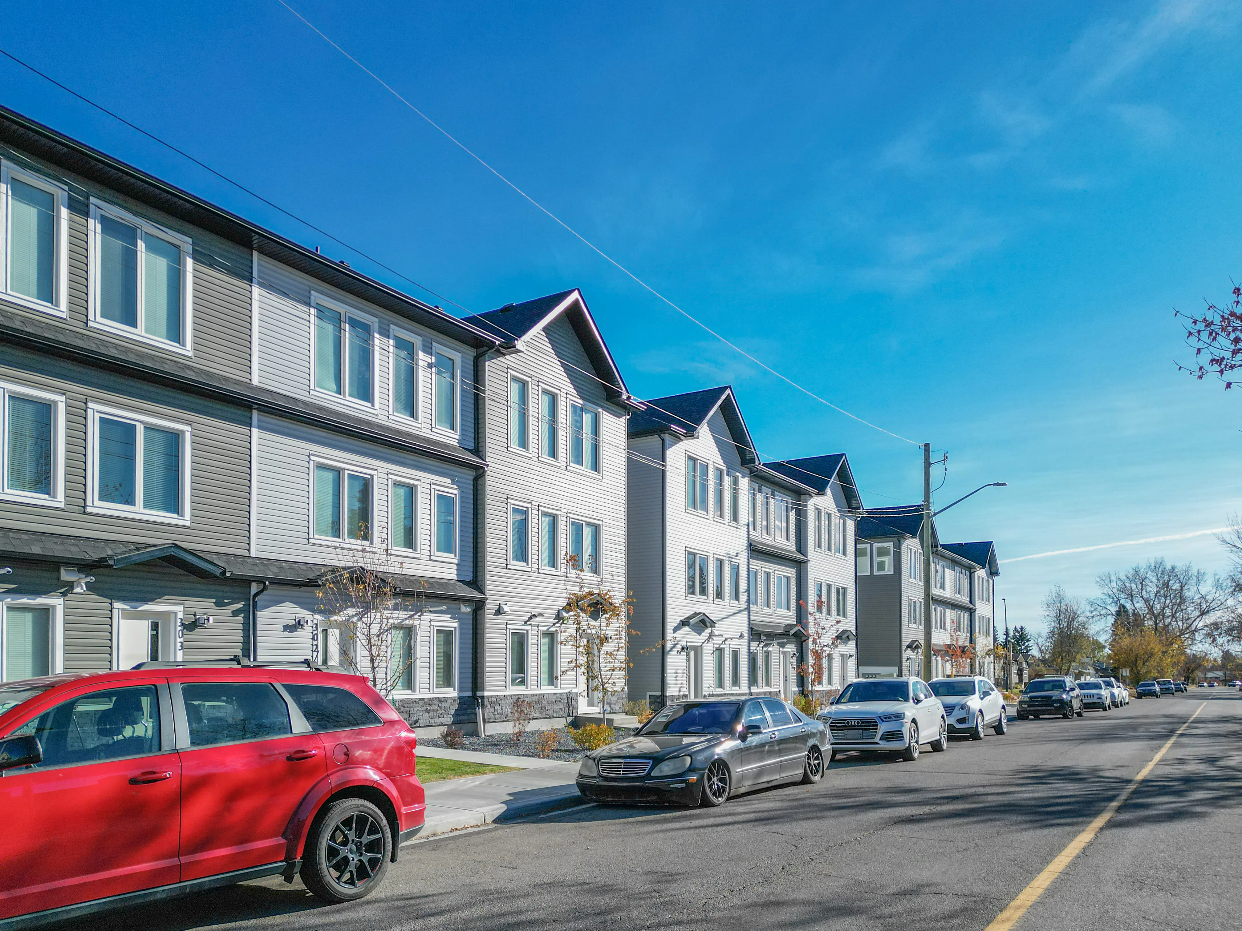 Row of modern three-storey townhomes along a street
