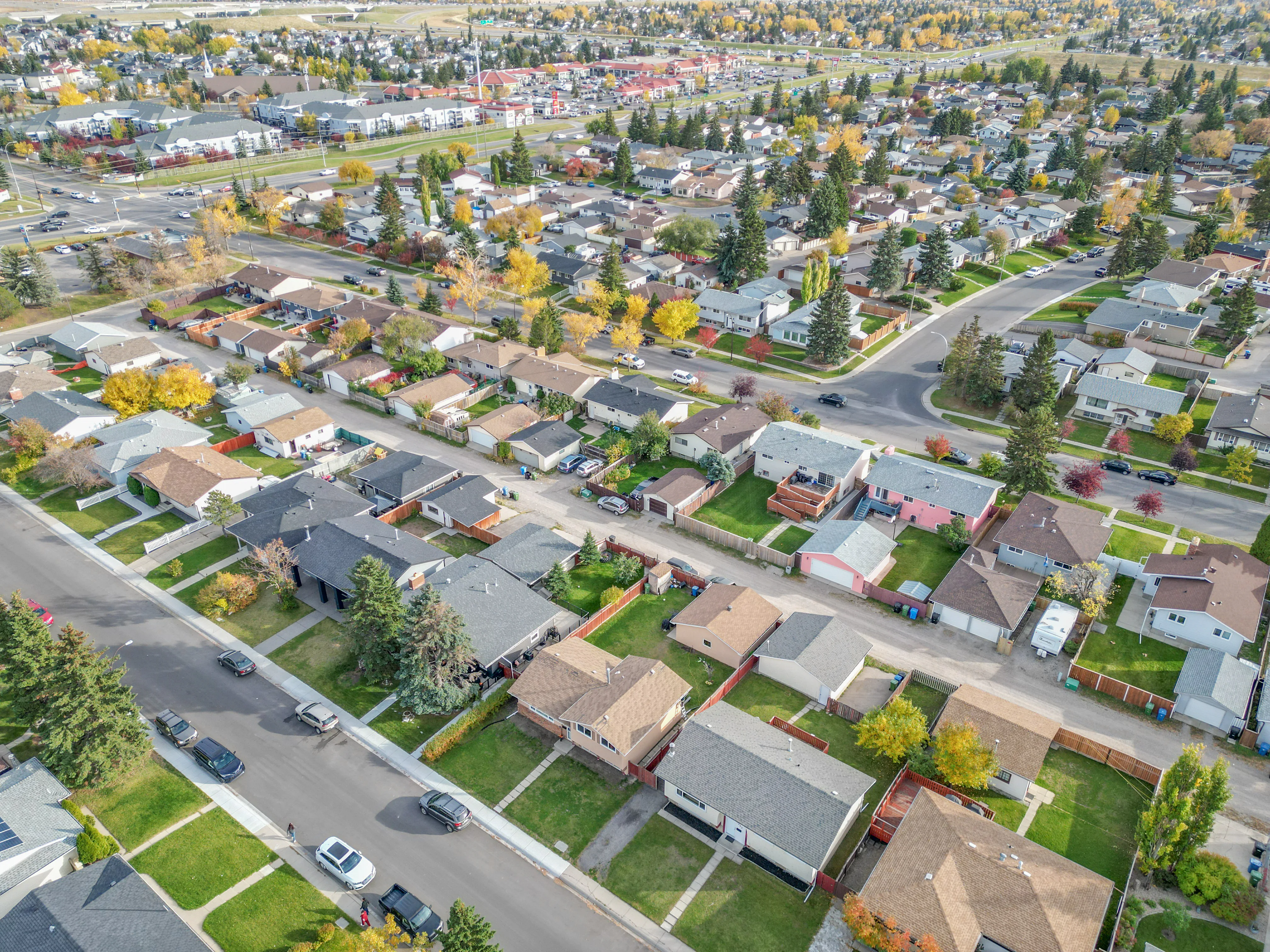 Aerial of older detached homes on tree-lined streets in autumn