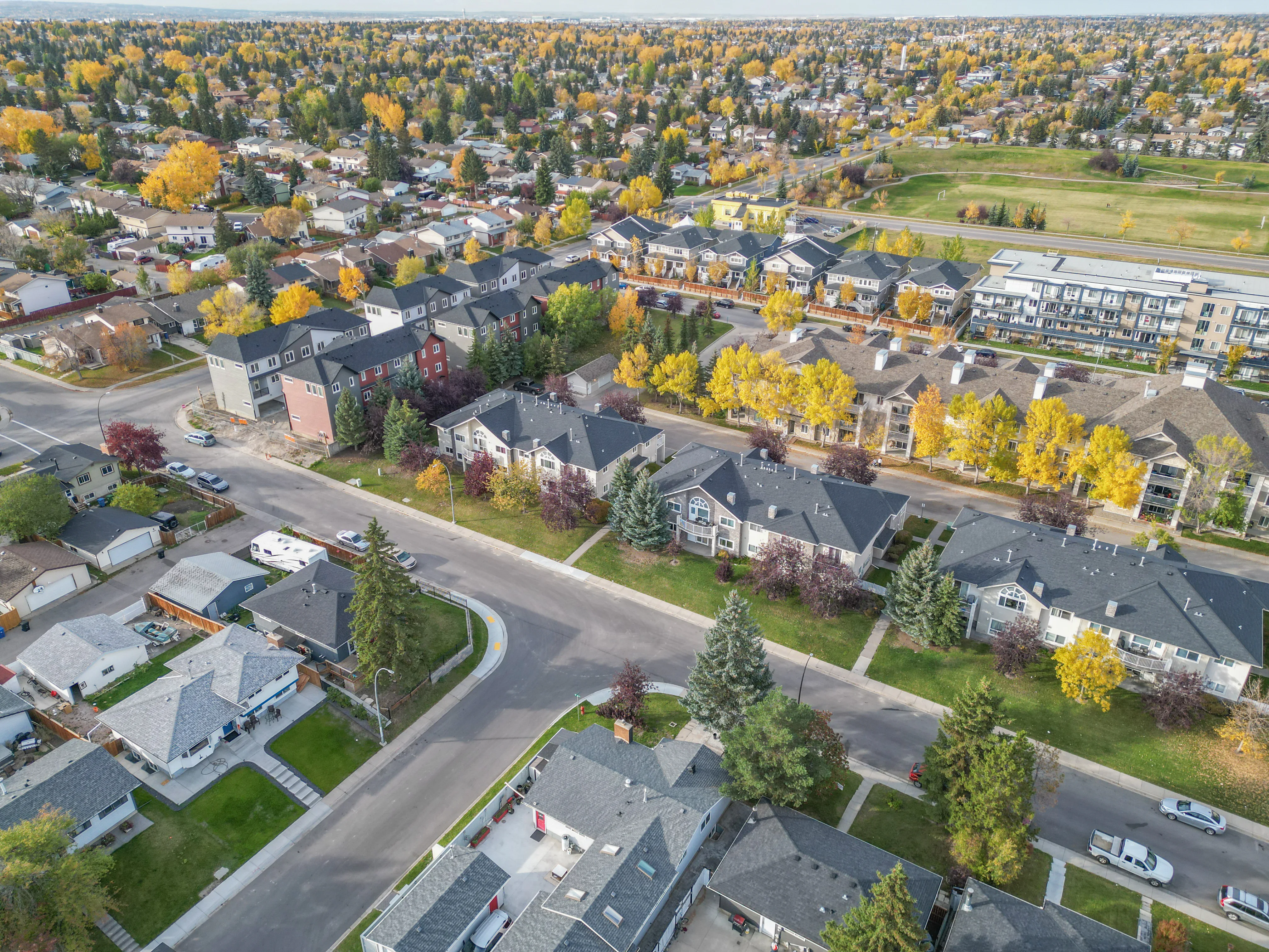 Aerial of townhomes and detached homes in autumn colours