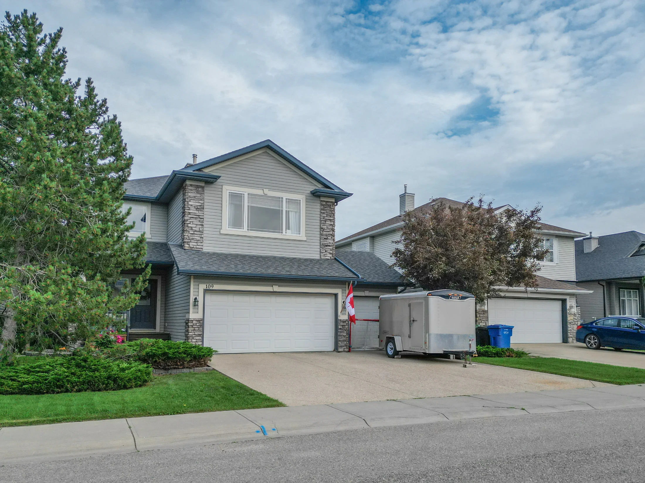 Two-storey homes with attached double garages and lawns