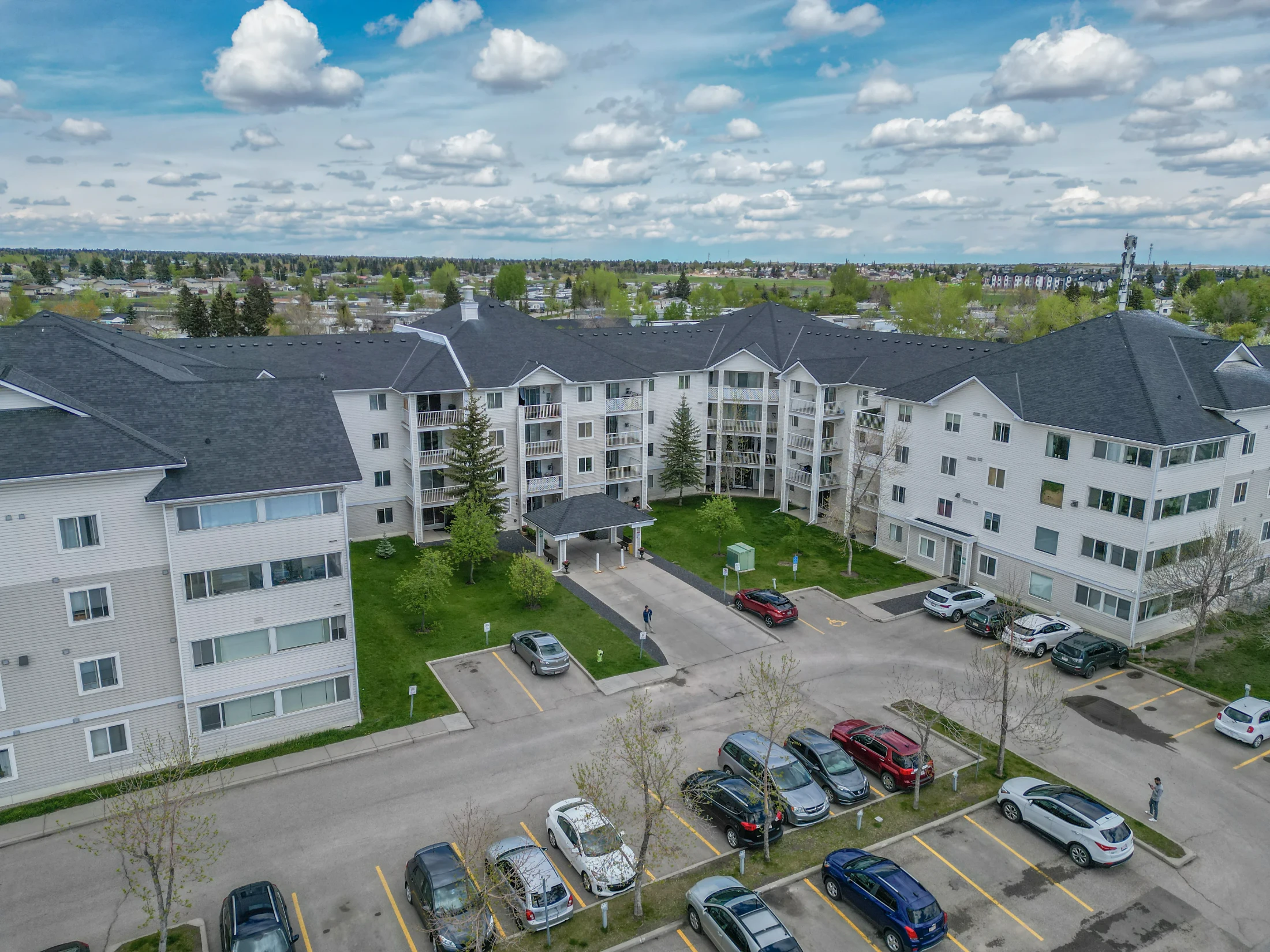 Four-storey condo complex around a landscaped courtyard