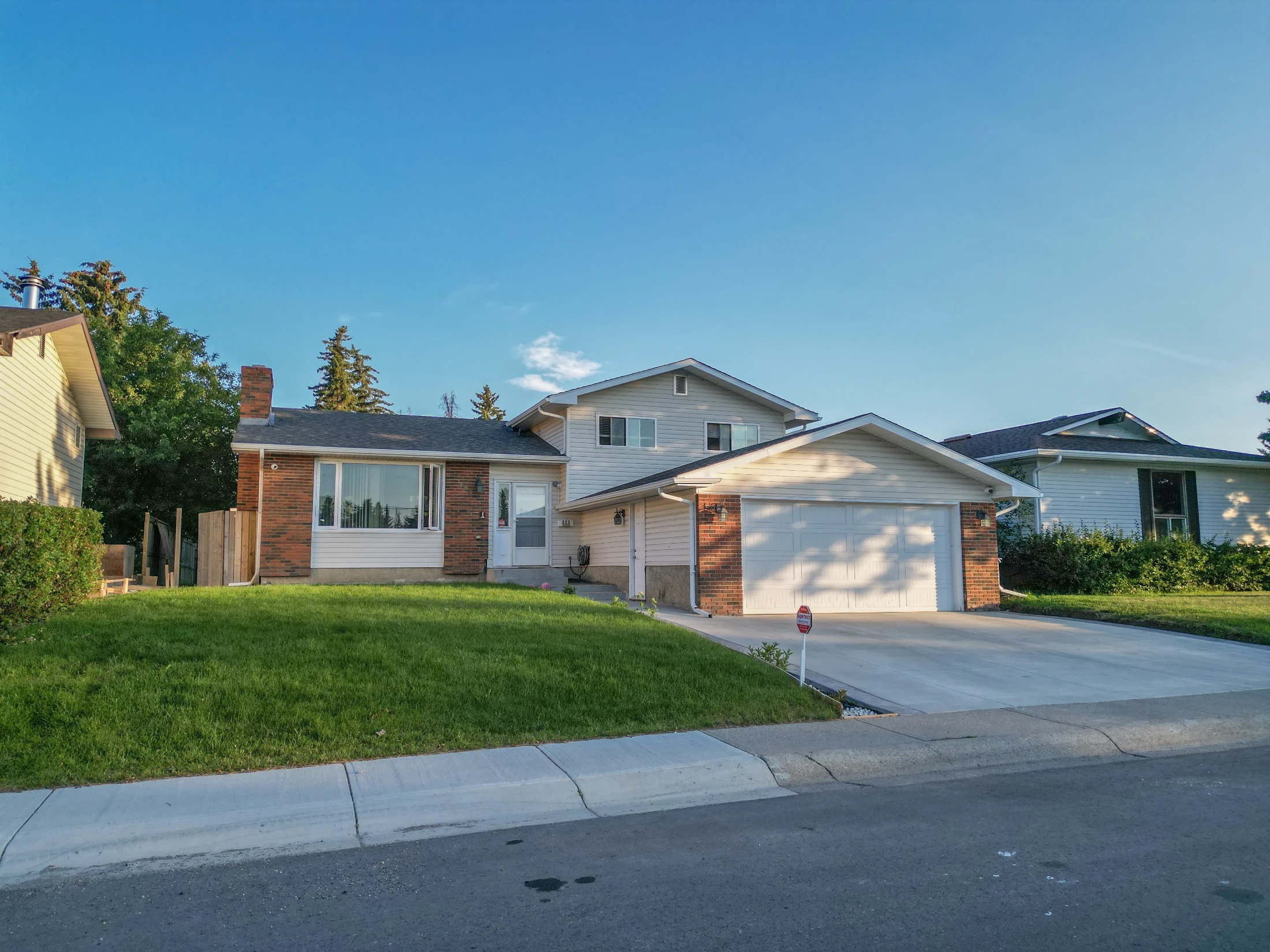 Bungalow with a brick front and an attached garage