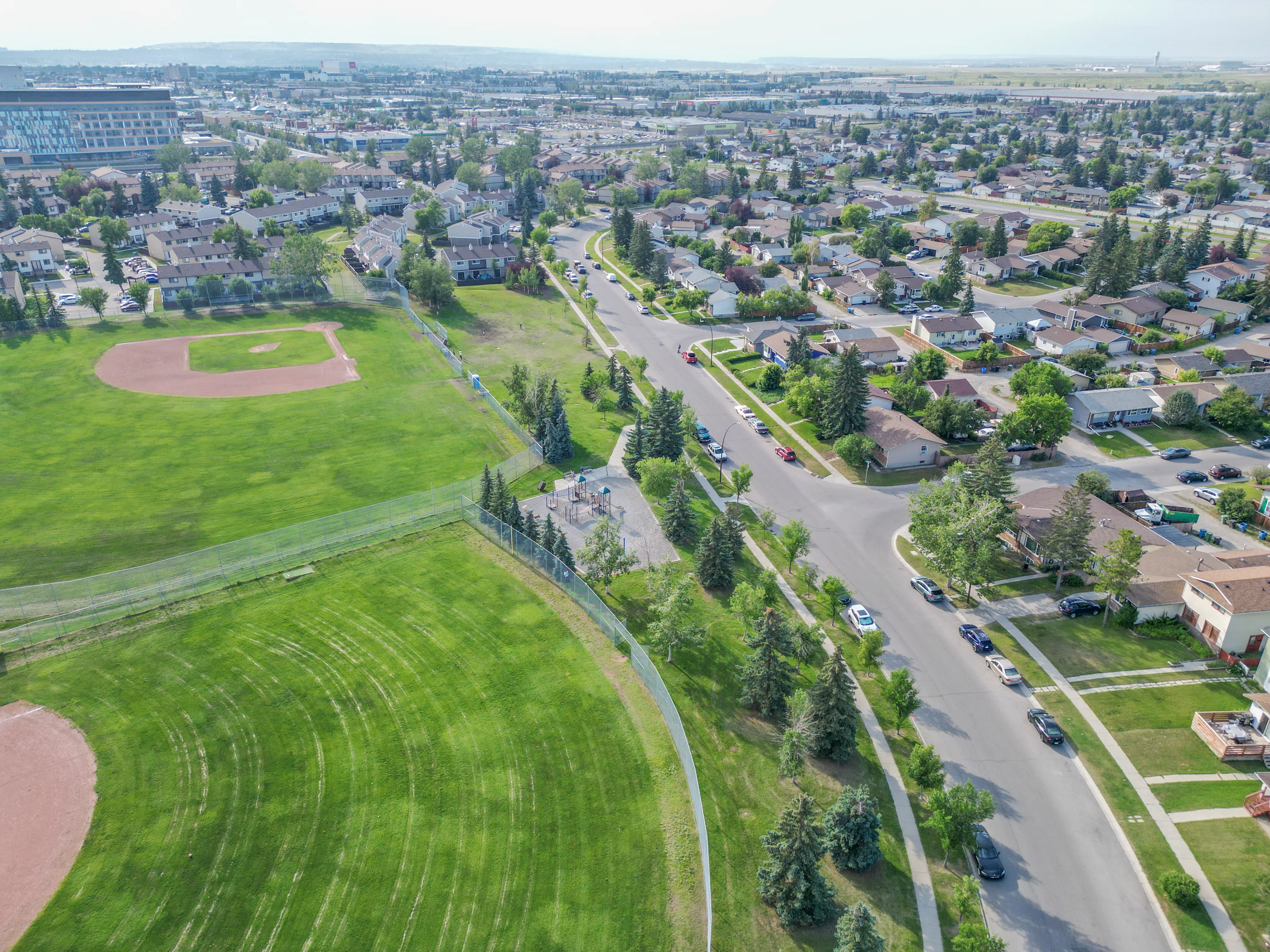Aerial of a community park with a ball diamond surrounded by homes