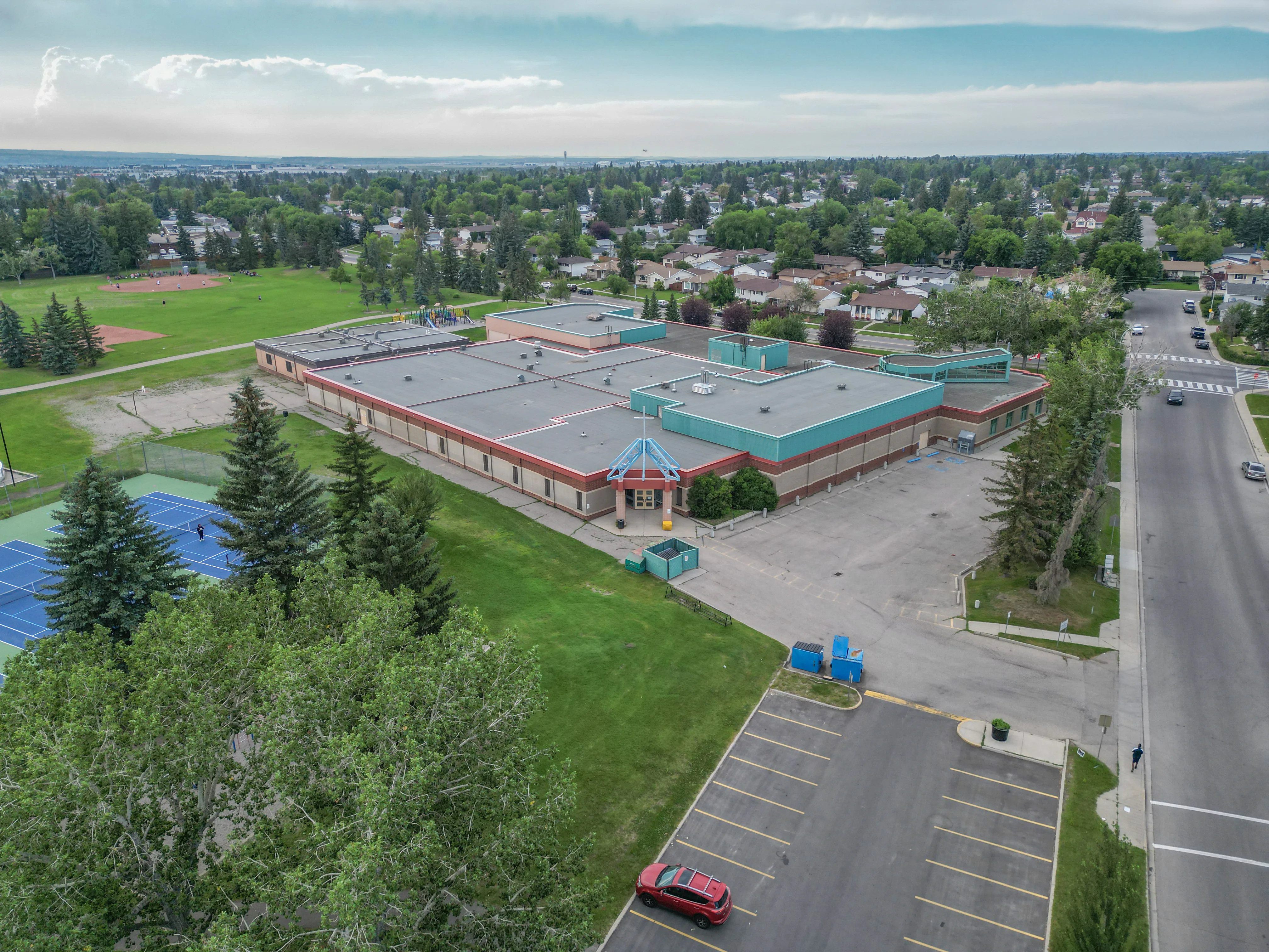 Aerial of a school with sports fields and nearby homes