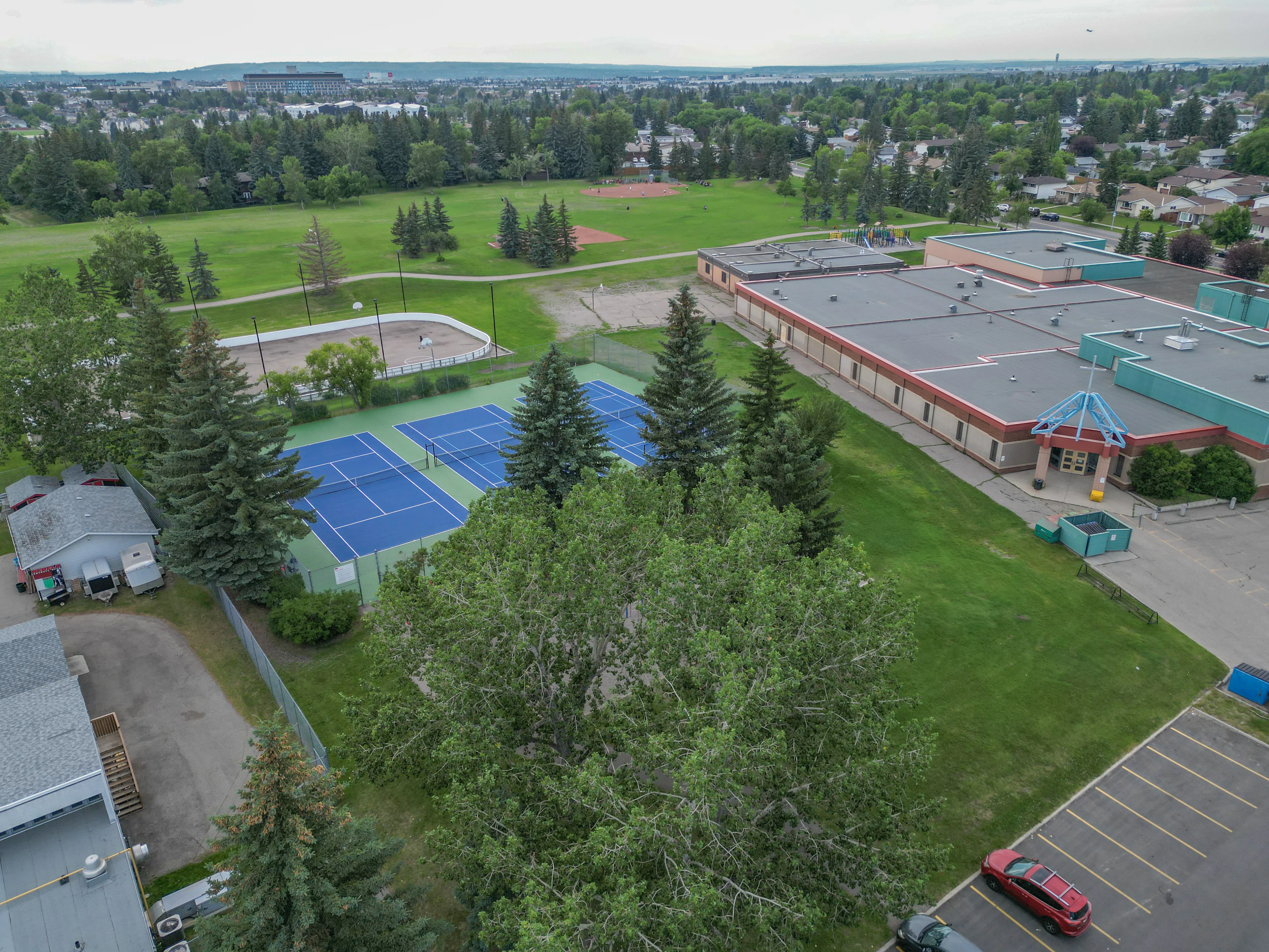 Aerial of a school with tennis courts and sports fields