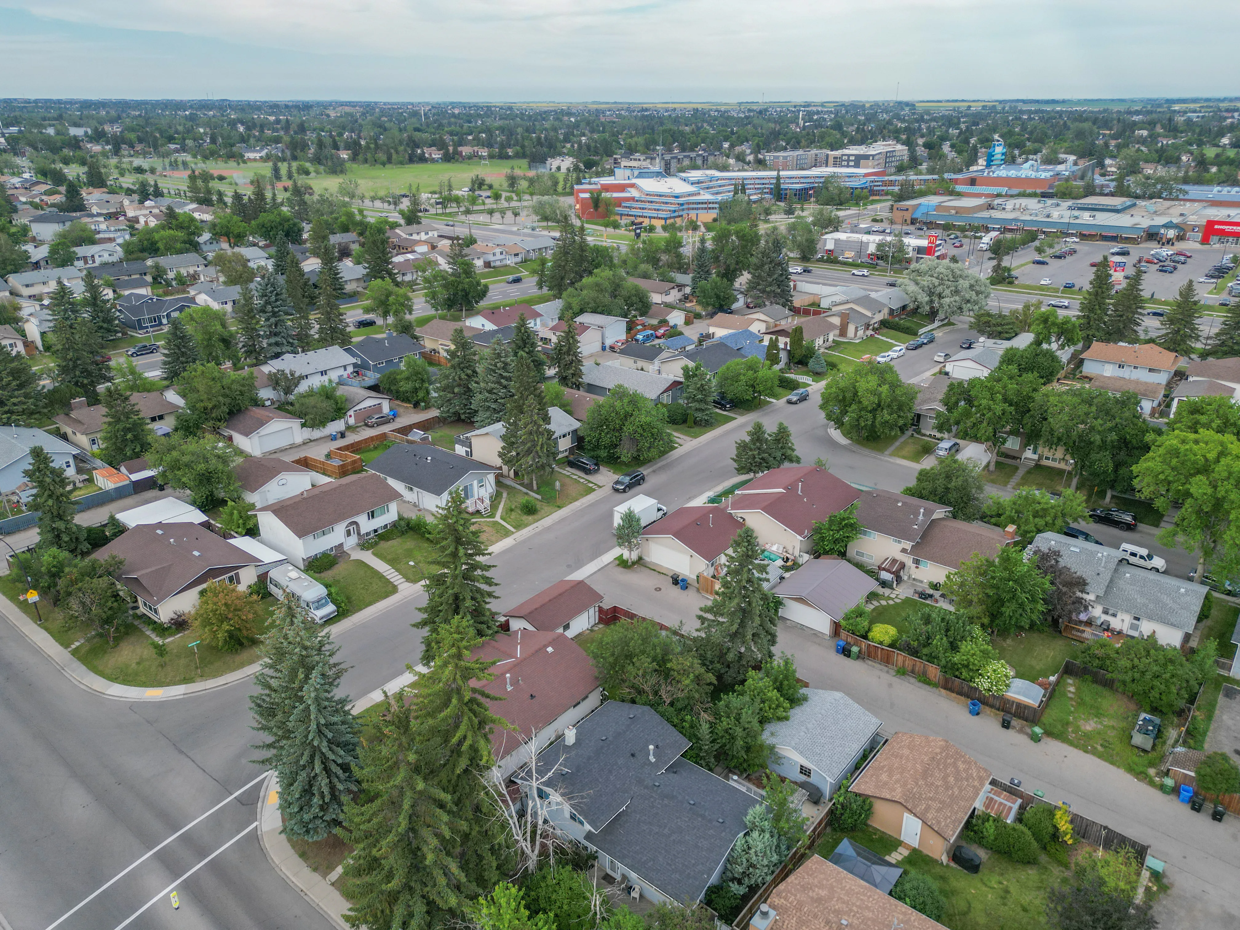 Aerial of a neighbourhood of detached homes and mature trees