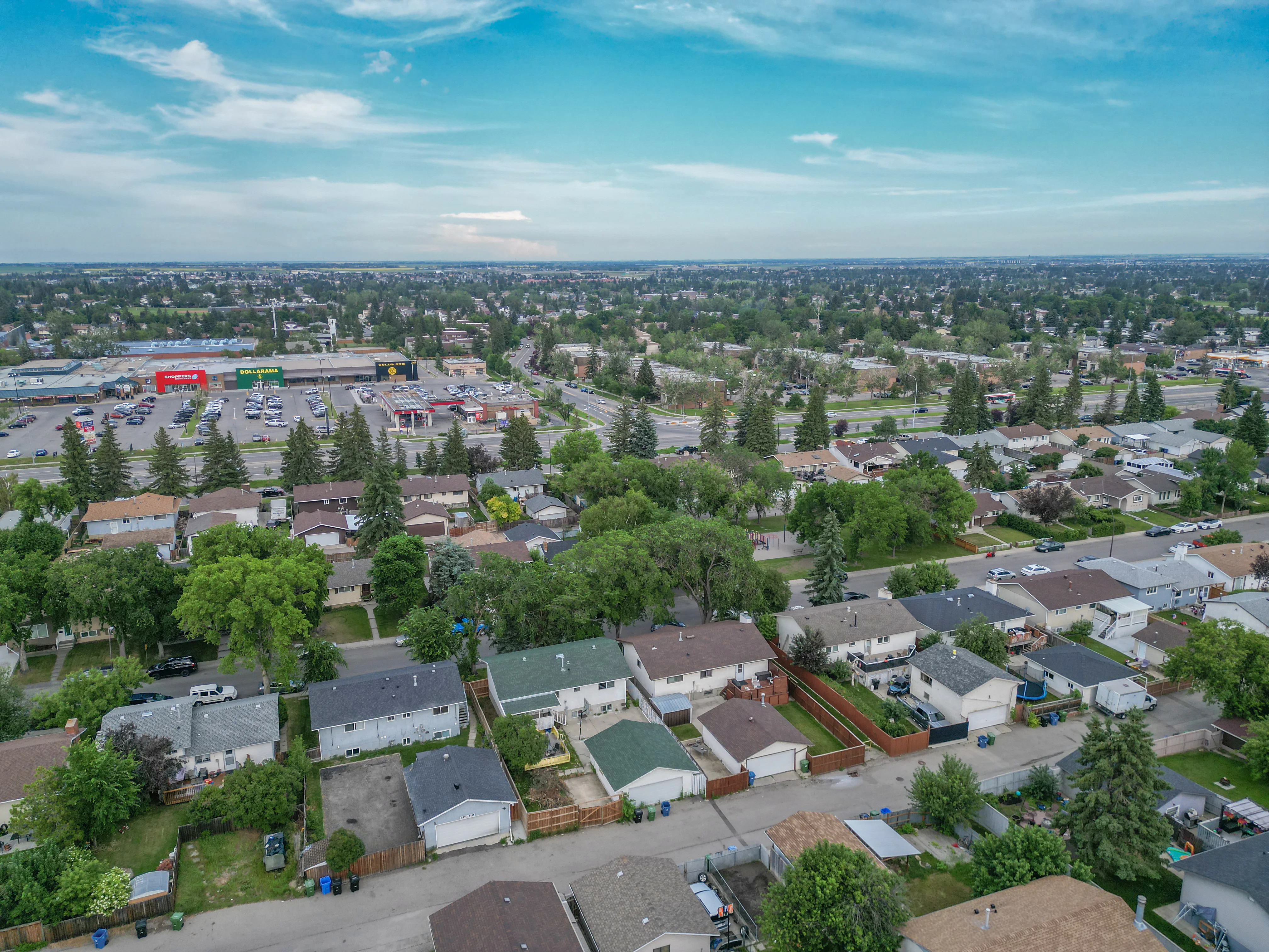 Aerial of homes and a shopping area in the distance