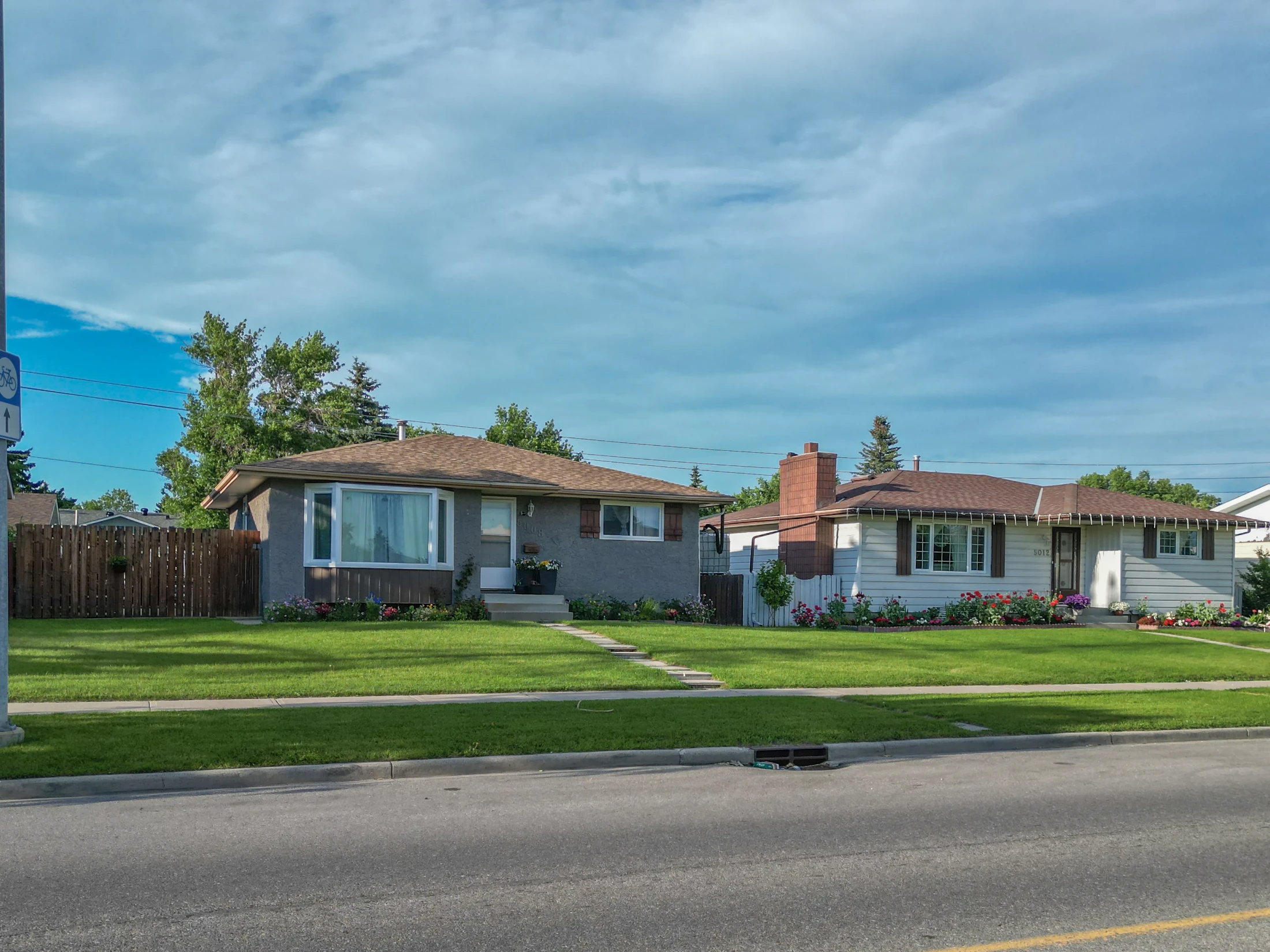 Bungalows with front lawns and trees on a quiet street