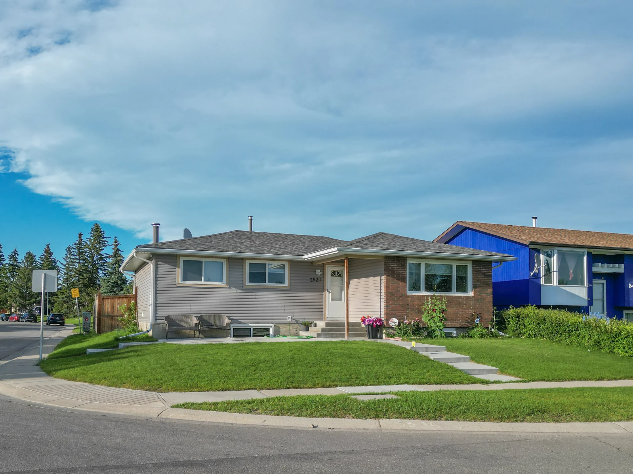 Bungalow with a front lawn on a corner lot