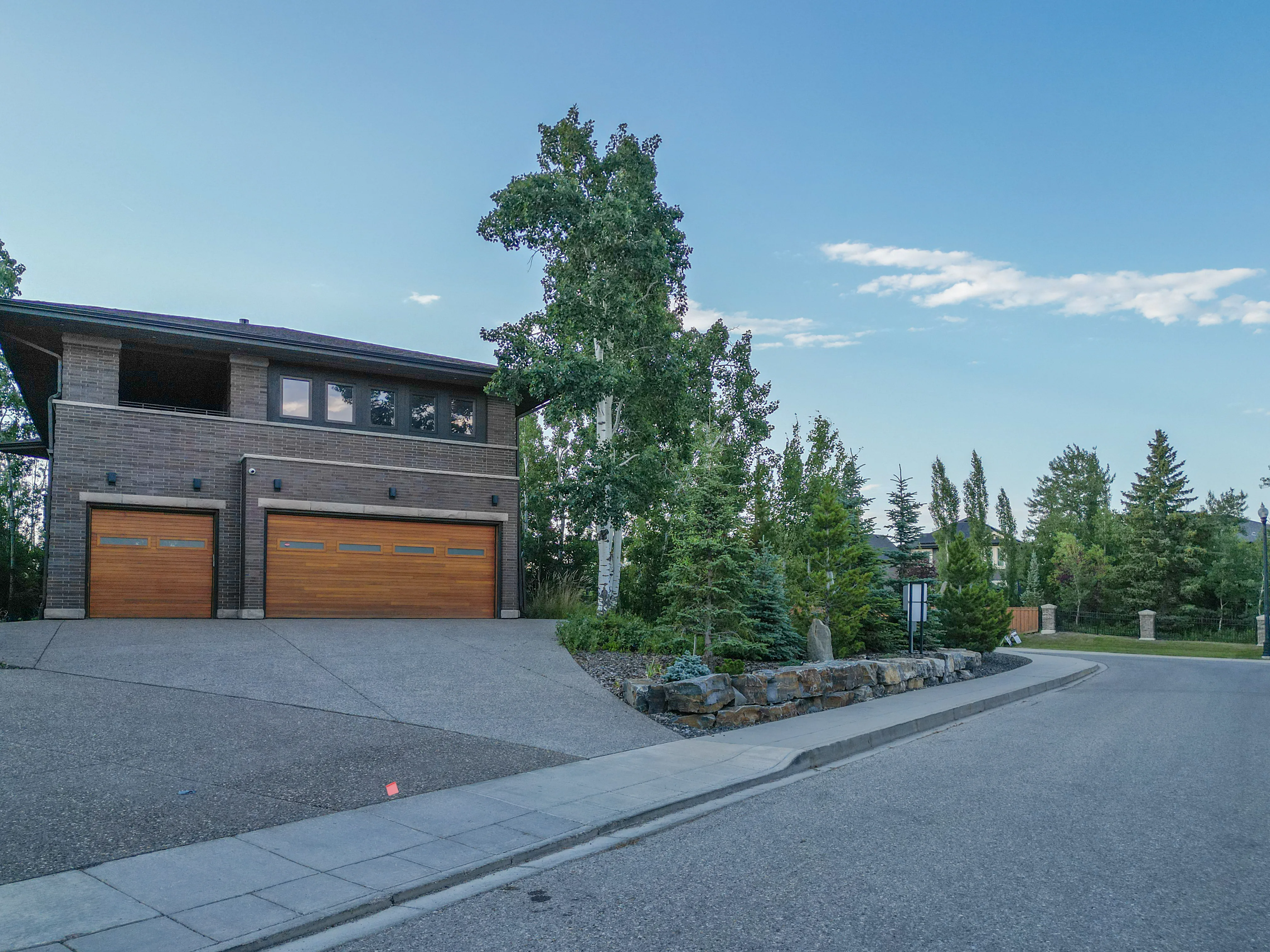 Two-storey home with a wood garage door and a stone front