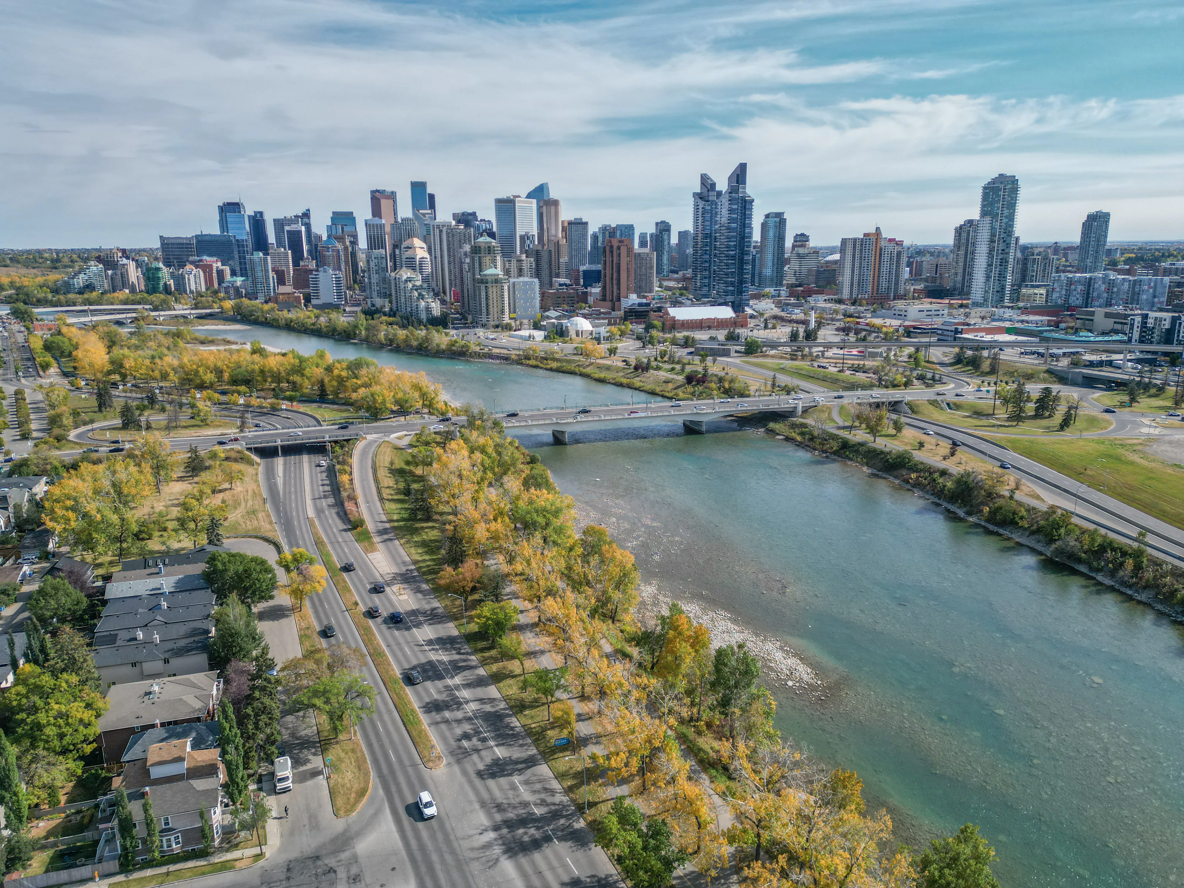 Aerial of a river pathway with homes and trees alongside