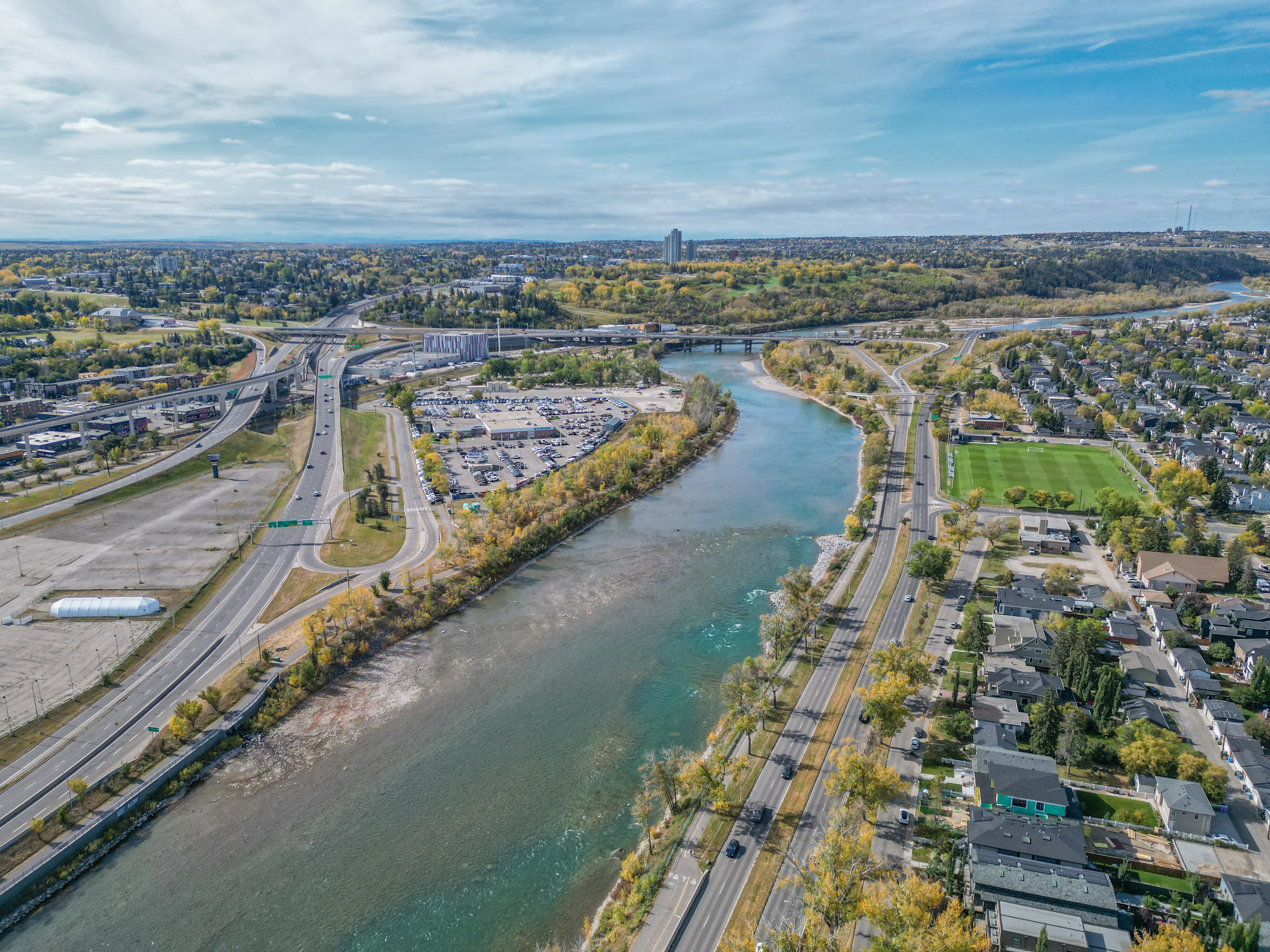Aerial of a river with pathways and trees along both banks