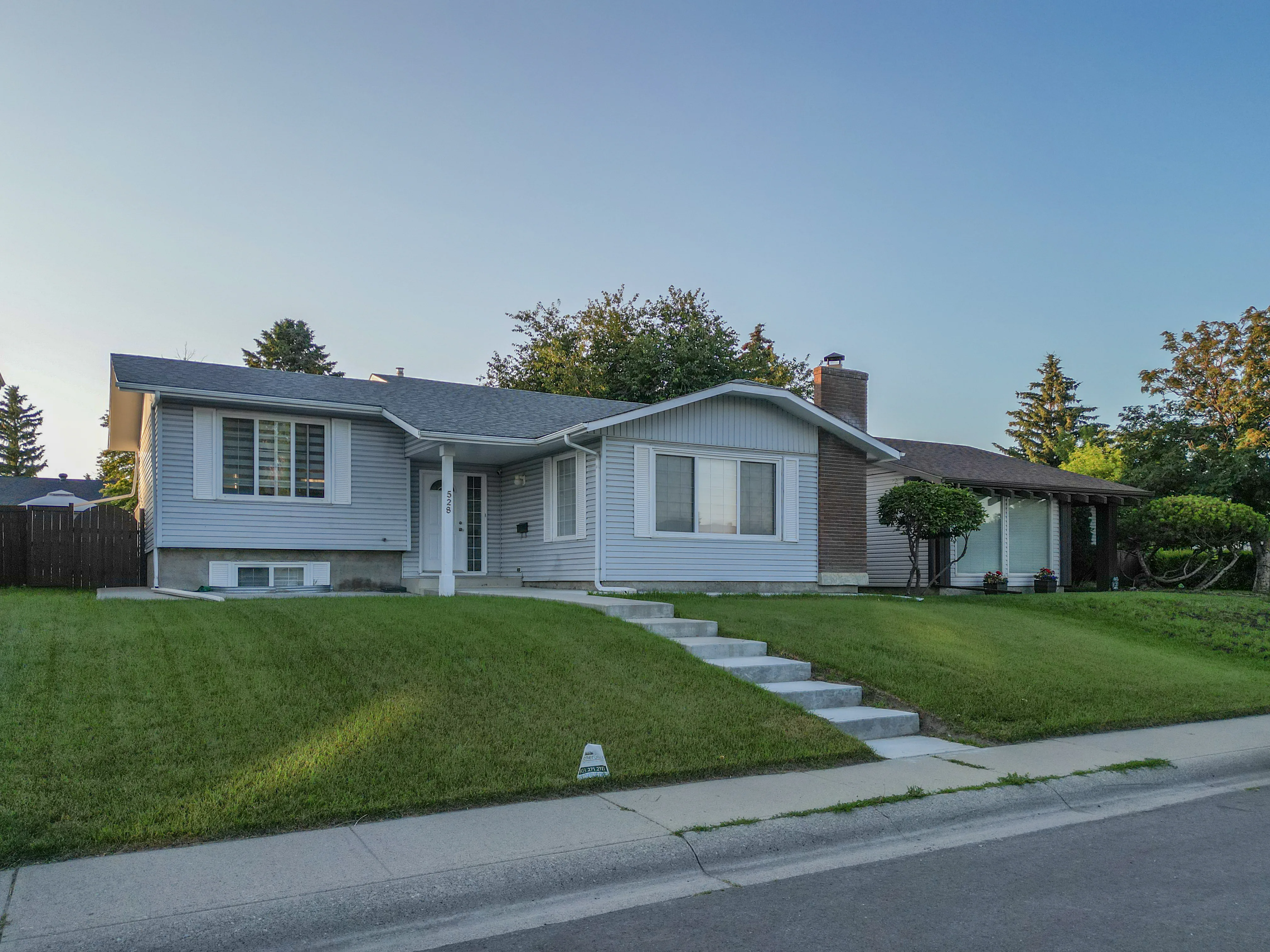 Two-storey home with a double garage on a sunny residential street