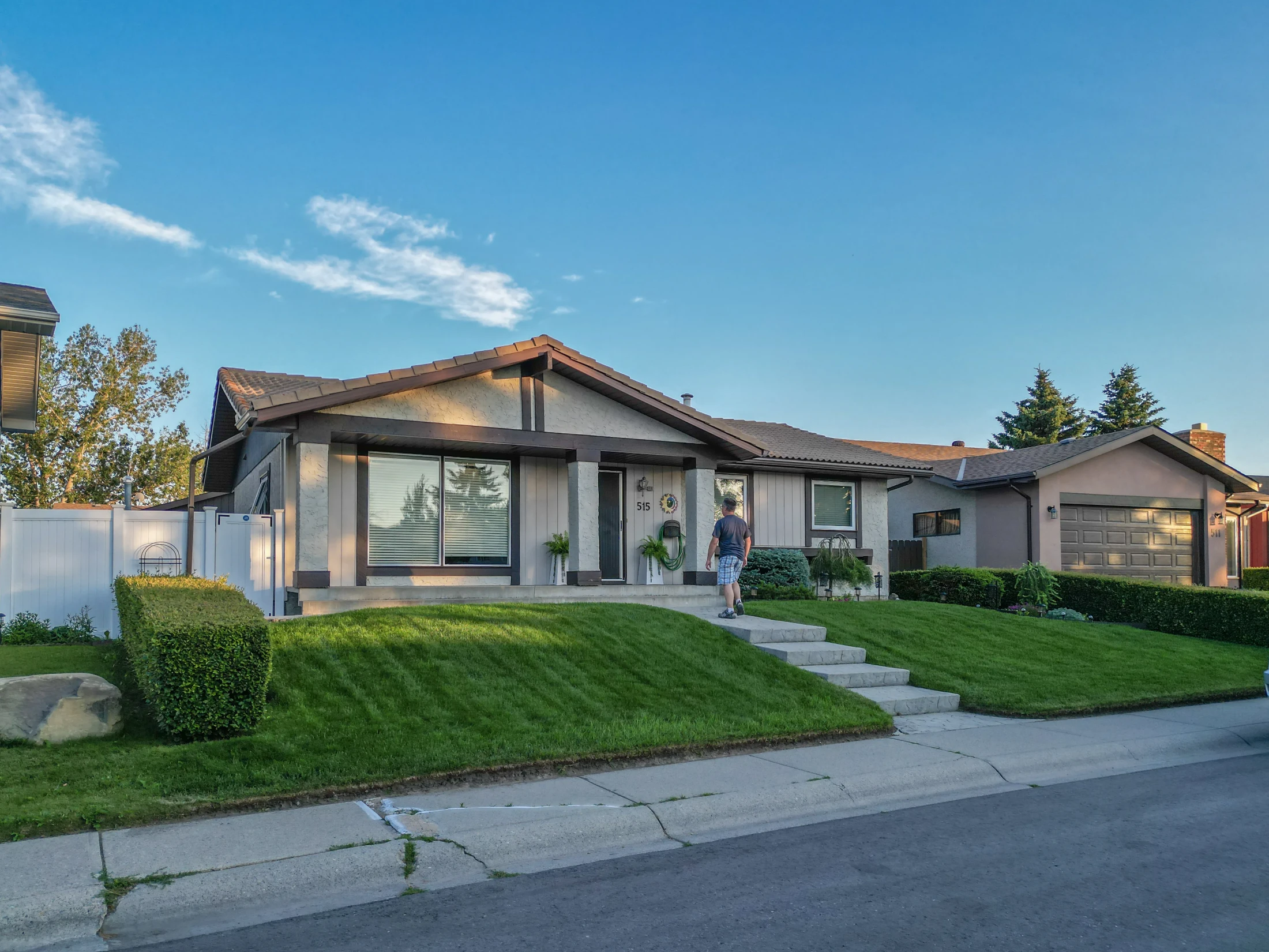 Renovated bungalow with a stone front and a wide driveway
