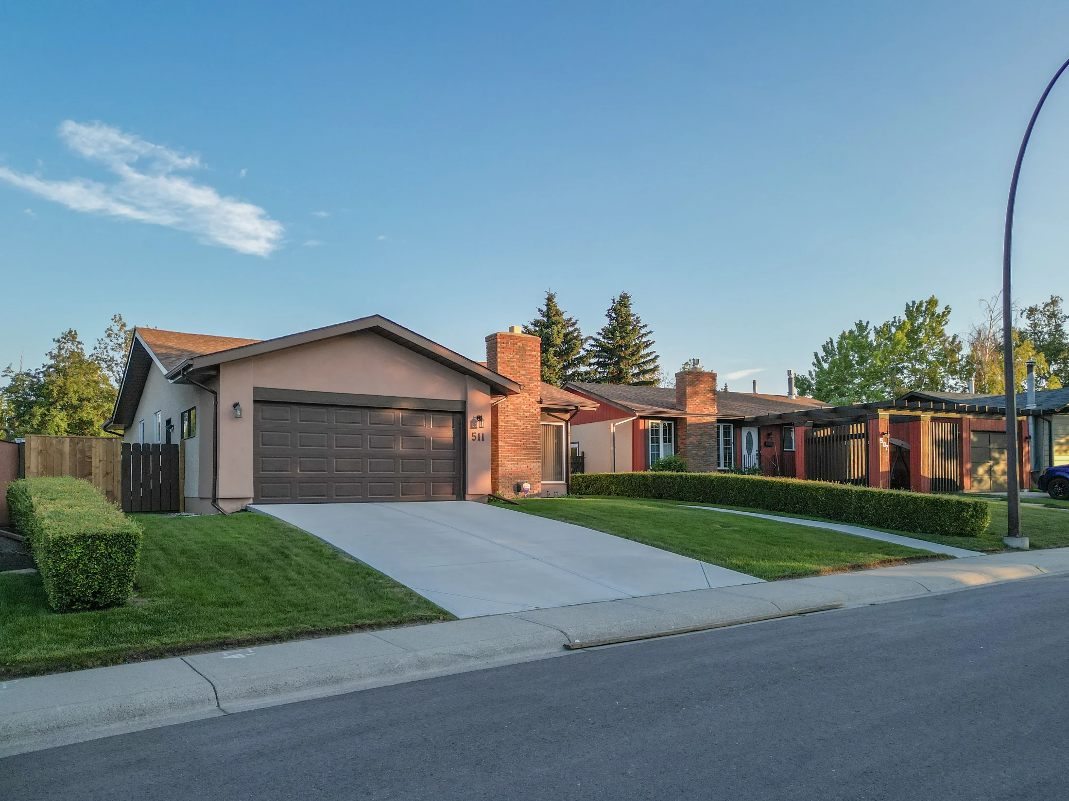 Bungalow with a brick front and attached garage