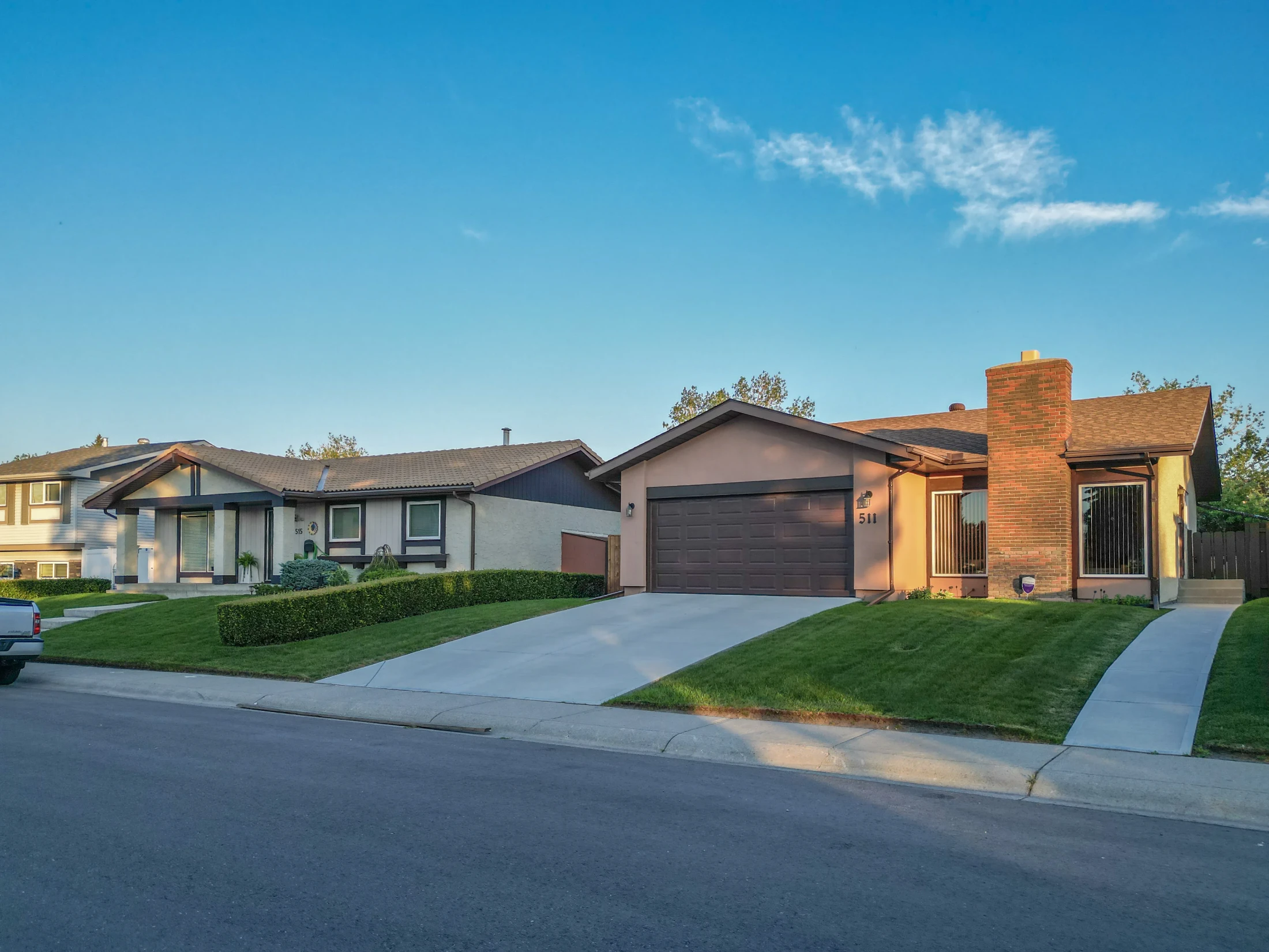 Row of bungalows with front-drive garages and lawns