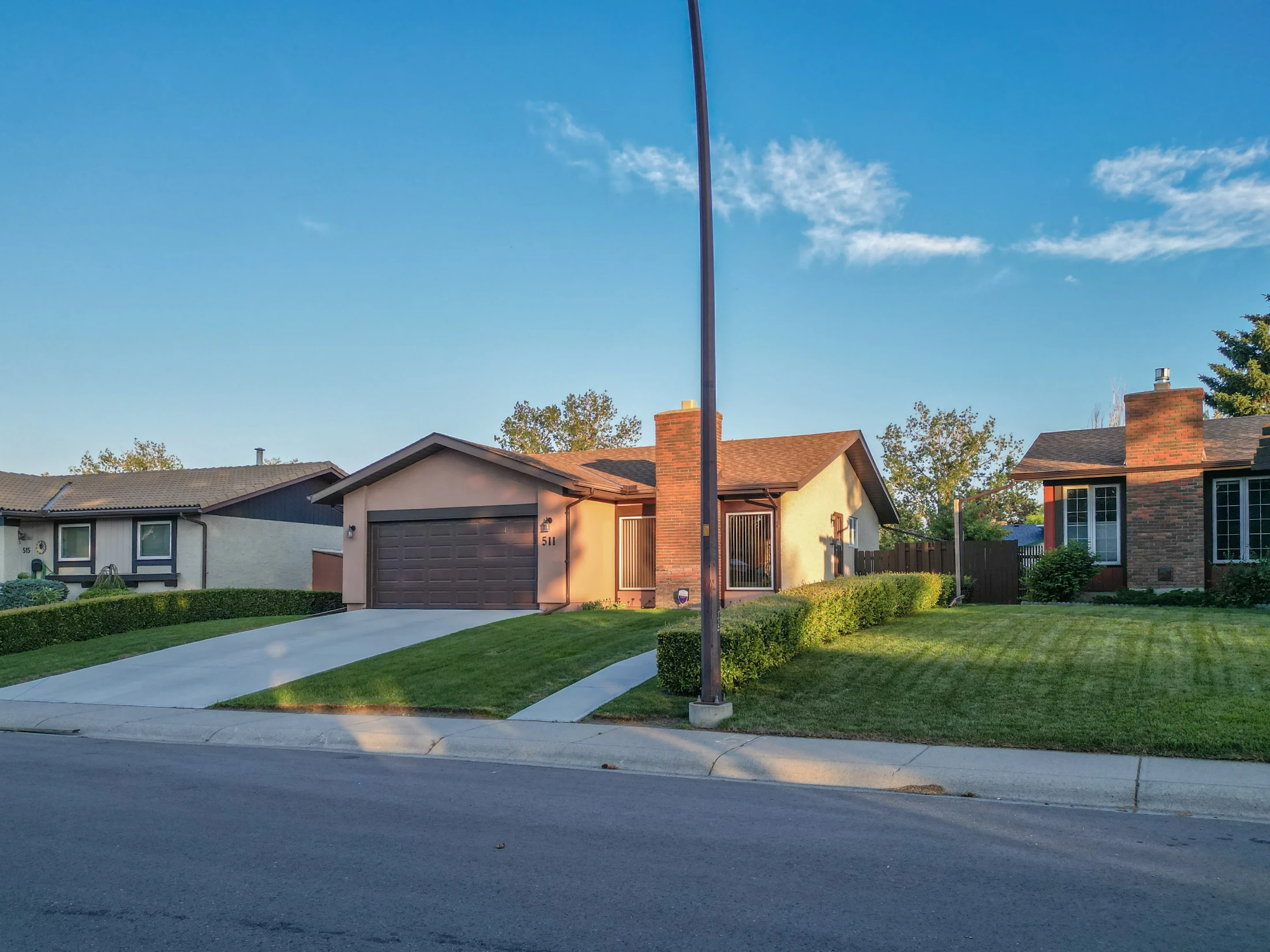 Bungalows with garages along a curving residential street
